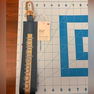 Lululemon Teal and Gold Never Lost Keychain- New